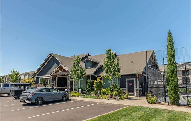A silver car is parked in a parking lot in front of a building at Forestplace Apartment Homes, Forest Grove, 97116