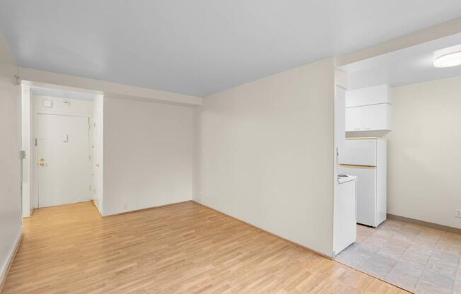 a living room with a hard wood floor and white walls
