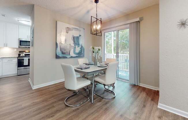 A dining room with a table and chairs.