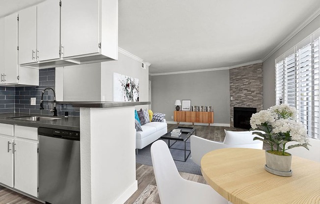 Dining room with view of stone accent wall and stainless steel kitchen.