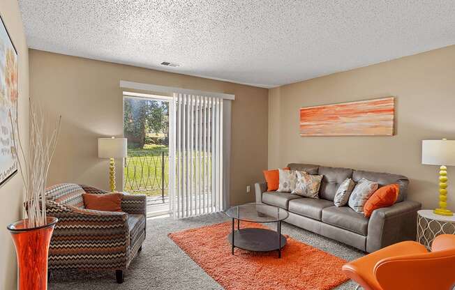 a living room with a couch and a chair and a table