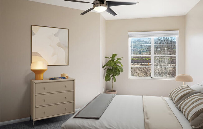 Model bedroom with ceiling fan at Reserve at Rancho Apartments