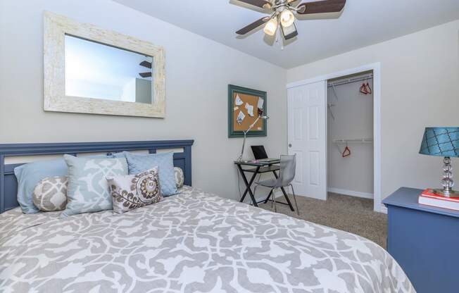 a bedroom with a bed and a ceiling fan