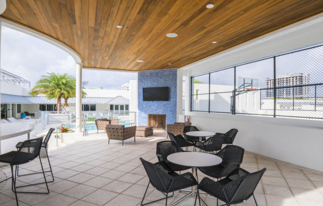 An outdoor patio with seating and television outside downtown Miami Apartments.