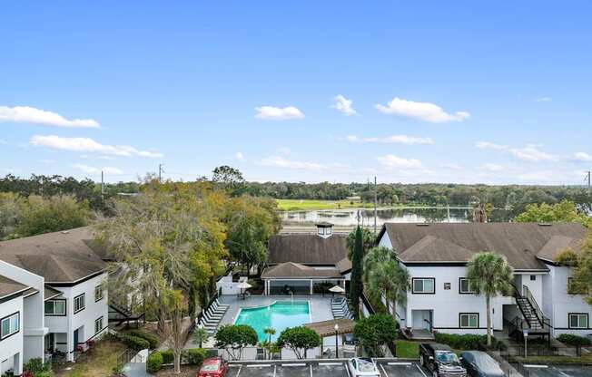 an aerial view of a neighborhood with a swimming pool and houses