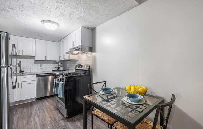 an open kitchen and dining room with a table and chairs