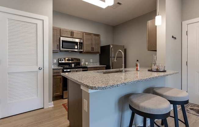 kitchen with granite countertops at the flats at big tex apartments in san antonio,