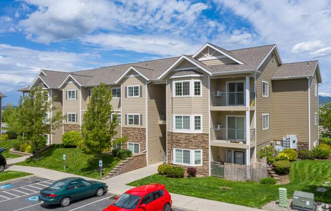 country vista at liberty lake apartment building with cars parked in front of it