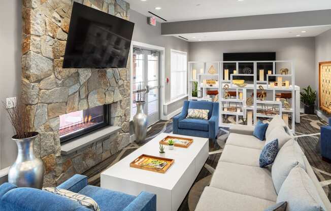 a living room with couches and a coffee table and a fireplace