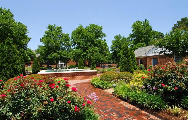 a close up of a flower garden in front of a house