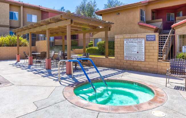 a hot tub in a patio with a pool