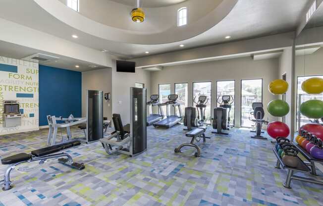 a spacious fitness center with treadmills and other exercise equipment