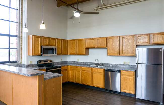 an empty kitchen with wooden cabinets and stainless steel appliances