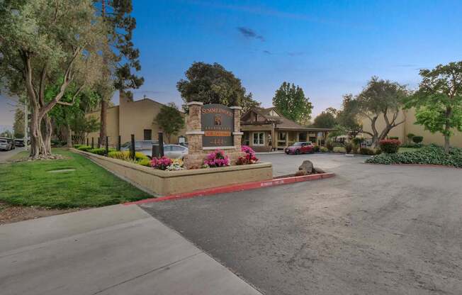 a street in front of a house with a driveway and a sign at Summerwood Apartments, Santa Clara, California