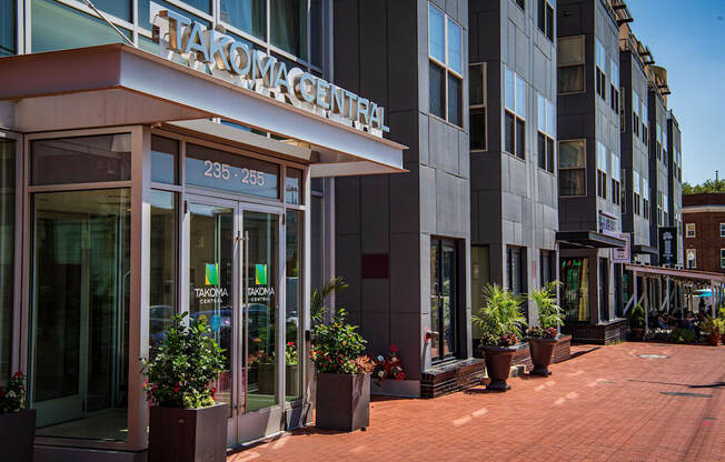 a view of the front of a building with potted plants in front of it