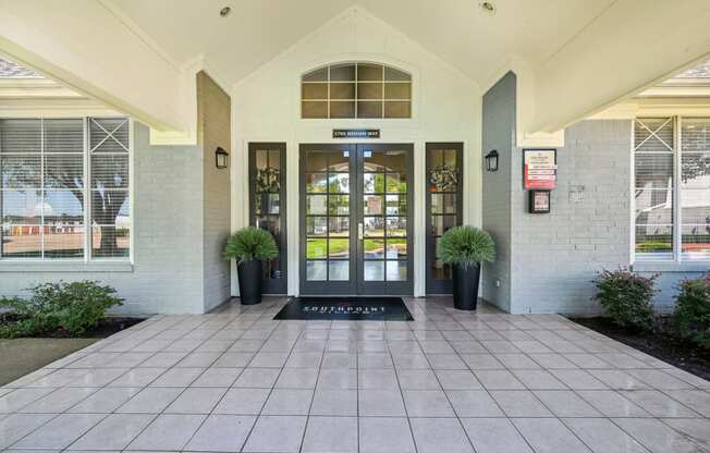 an entrance to a building with doors and windows