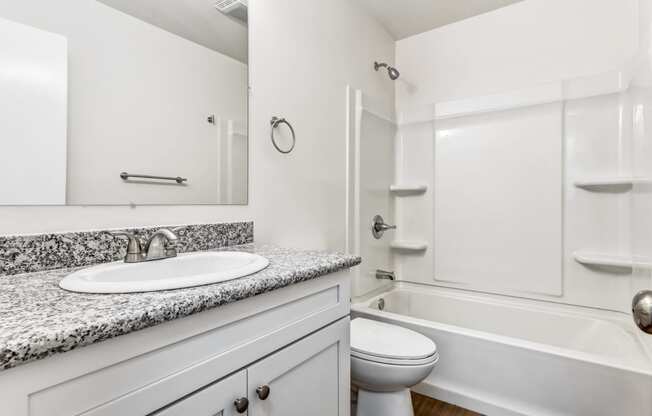 Whitney Manor Apartments in Gretna, LA photo of bathroom with sink, toilet and bathtub