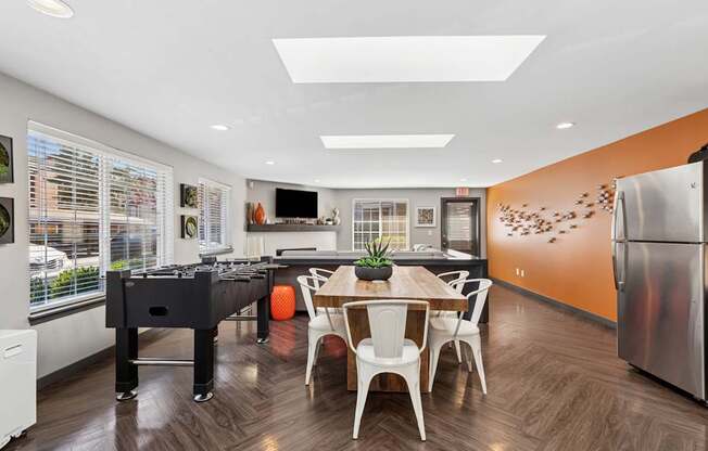 A kitchen with a dining table and chairs.