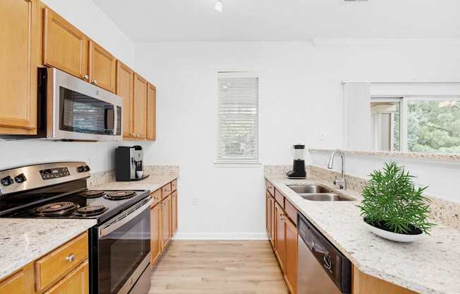 A kitchen with wooden cabinets and a white countertop.