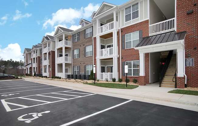 Apartment buildings with patio or balcony; parking lot