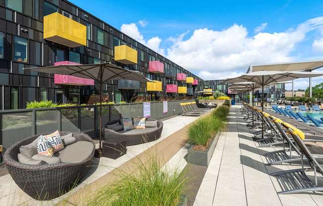 Poolside Lounge Area with Cozy Outdoor Seating and Lush Landscaping