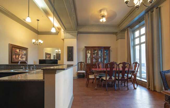 a dining room and kitchen with a table and chairs