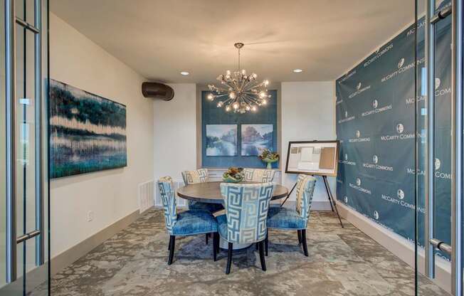 A dining room with a table set for six.