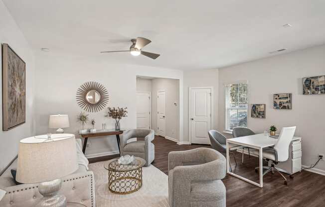 a living room with a dining room table and chairs and a ceiling fan