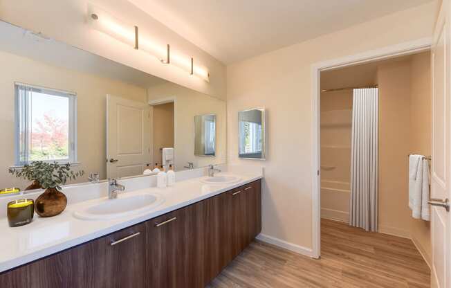 a bathroom with two sinks and a large mirror