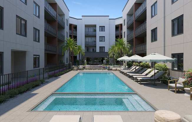 A large swimming pool in the middle of a courtyard surrounded by lounge chairs and umbrellas.