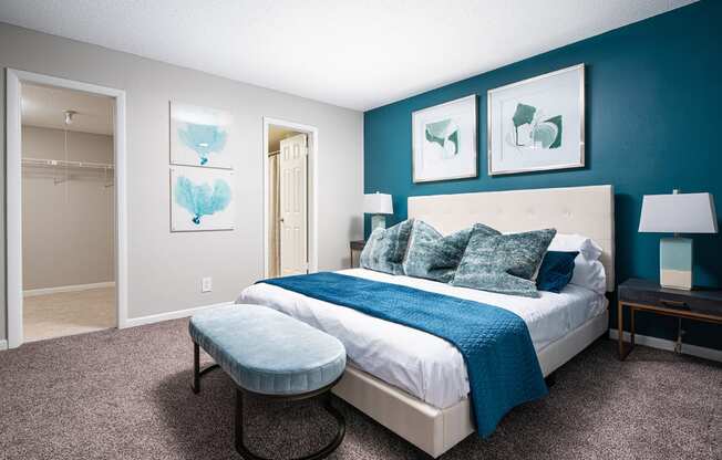 a bedroom with a bed and a blue wall and a closet at Fairways of Inverrary, Lauderhill, 33319