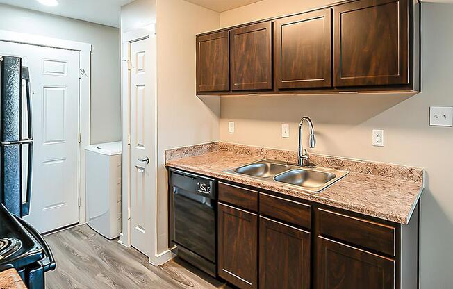 a kitchen with a sink and a refrigerator