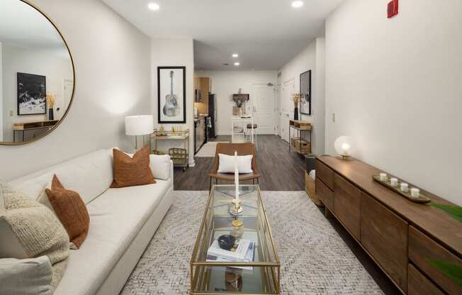 a living room with a white couch and a glass coffee table