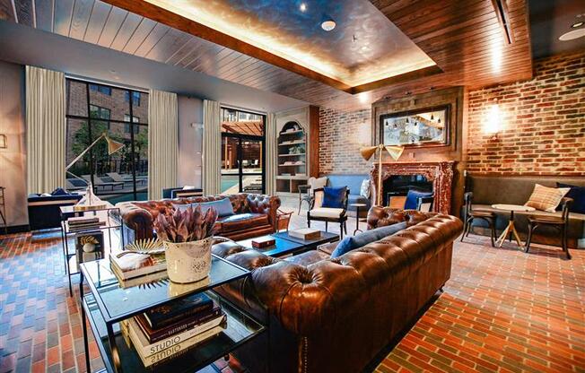 A living room with a brown leather couch and a glass coffee table.