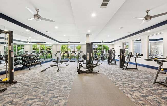 Bright fitness studio with floor-to-ceiling mirrors at Harlow River Oaks apartments in Houston, TX.