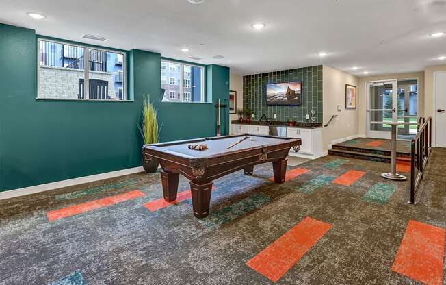 a game room with a pool table and a tv