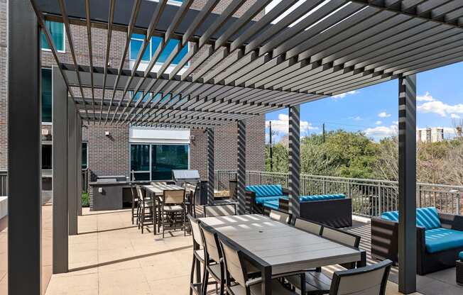 a patio with tables and chairs and a pergola