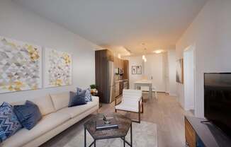 A living room with a white couch and a coffee table.