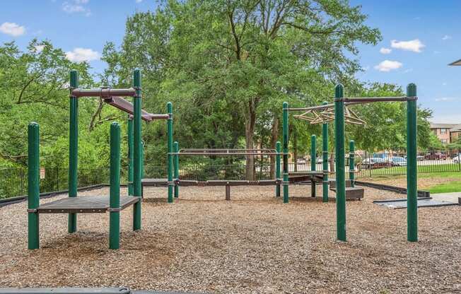 A playground with a swing set and a seesaw.