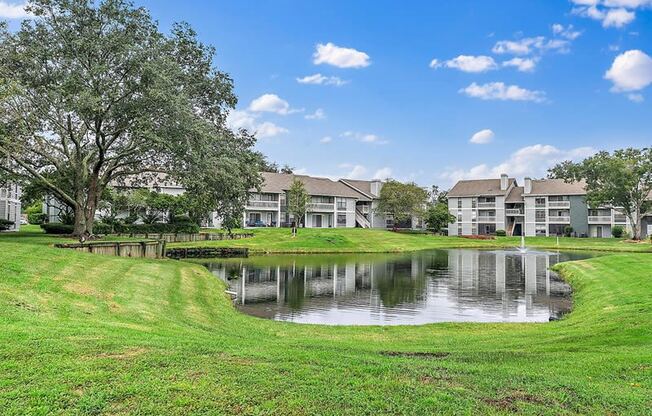 swimming pool with a wooden deck next to a body of water