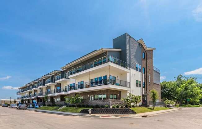 a large apartment building on the corner of a street