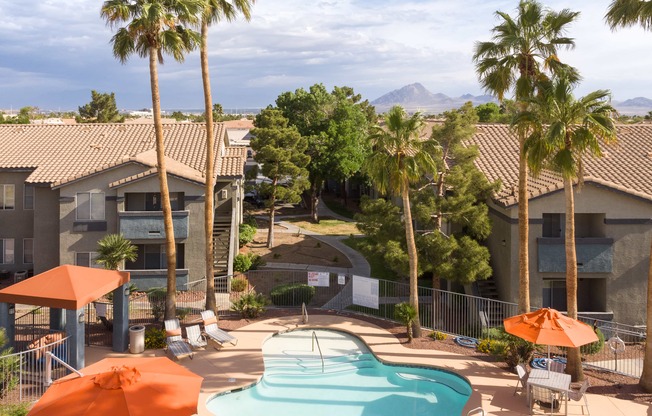 an aerial view of a pool at the resort with palm trees