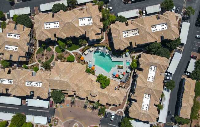 arial view of a large mansion with a swimming pool in the middle of it