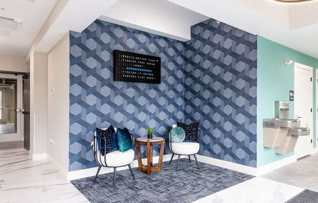A wall with a pattern of blue hexagons with a black sign on it.