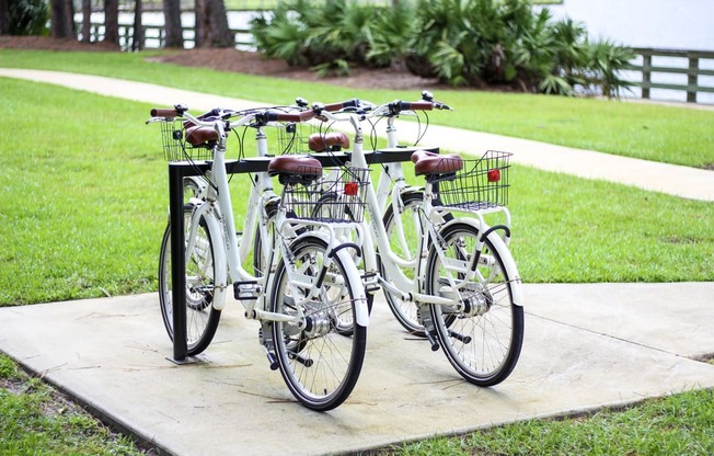 a row of bikes parked on a sidewalk
