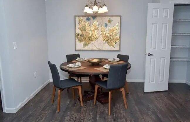 a dining room with a table and chairs