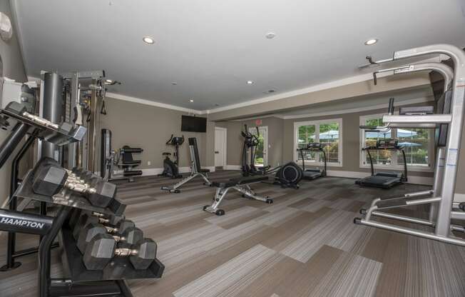a gym with weights and cardio equipment in a home for sale