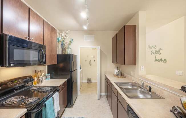 a kitchen with a stove and a sink and a refrigerator