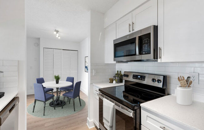 A modern kitchen with a table and chairs.