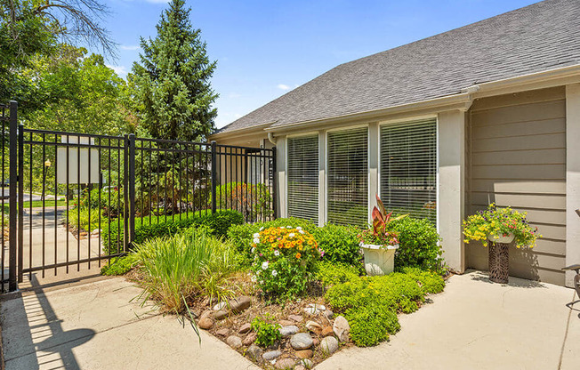 the front yard of a house with a driveway and a gate